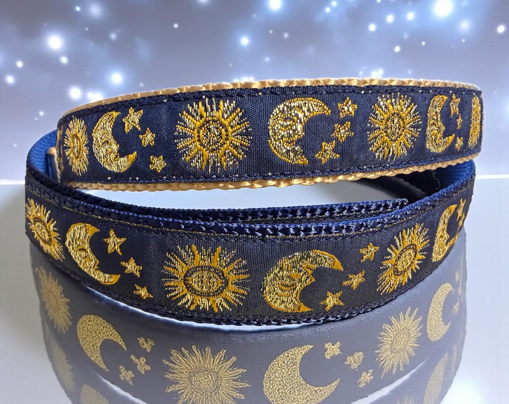 Navy blue celestial dog collar with gold moon and sun patterns and gold metal buckle