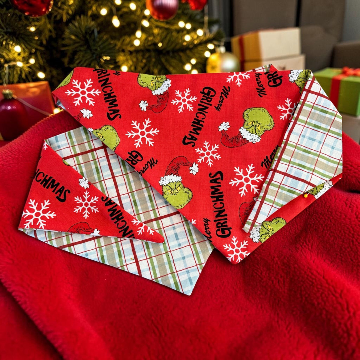 Winni&Me Woofwear Merry Grinchmas dog bandana in red with Grinch print, reversible to a festive Christmas plaid.